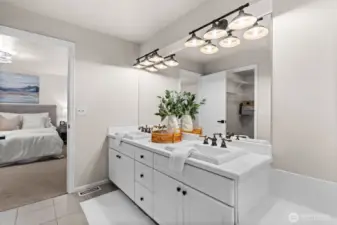 A 5 piece ensuite bathroom includes dual vanities, a walk in closet, shower, soaking tub and private water closet.