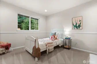 One of two guest suites on the upper floor is spacious and bright.