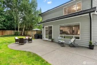 An expansive patio wraps around the side of the house where you will find a hot tub.