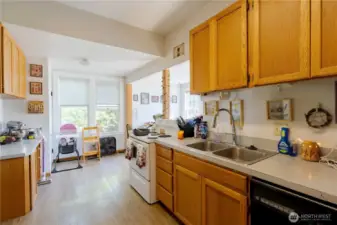 Kitchen facing stairs to basement and utility room.