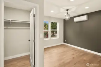 Upper level primary suite with mini-split heating/cooling system & 8 ft ceilings.