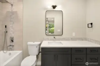 Luxury primary ensuite bath with custom cabinets, Italian tile floor & bath