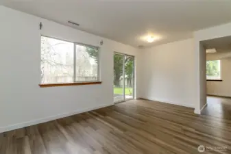 Family room. Great spot to put a desk for remote working or home office. Fresh interior Paint and new LVP flooring and carpet through-out.