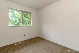 One of the upstairs bedrooms with generous closet space not pictured. Fresh interior Paint and new  carpet through-out.