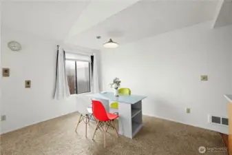 Bright dining area with large window perfect for meals or a workspace