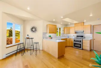 Kitchen with canned lights. Stainless fridge and range. Beautiful hardwood floors.