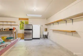 Two car garage with workbench, wash basin and extra fridge & freezer that convey.