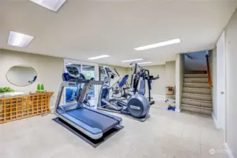 Flex-room #1 on ground floor set up as gym.  Flex Room #1 has a walk out covered patio for indoor-outdoor gym/flex room options. Also configurable as media room, family room, extra bedroom or second office.