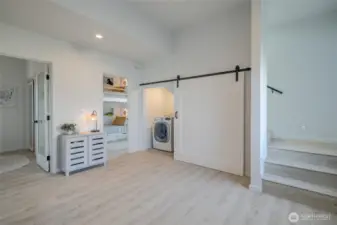 View of utility closet and stairs to second floor where the Great Room and Primary Suite are located.