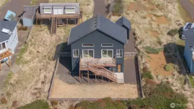 View of house showing fenced in yard. Plenty of space to expand outdoor living if wanted.