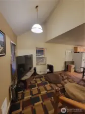 From the staircase back into the living room with partial vaulted ceiling.
