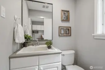 A convenient 1/2 bath located just off the kitchen and laundry room, perfect for guests and easy access from the main living areas.