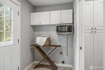 The functional laundry/mudroom features convenient access to the backyard.
