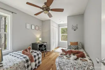 The second bedroom offers plenty of space, featuring a large closet and double windows for added light.