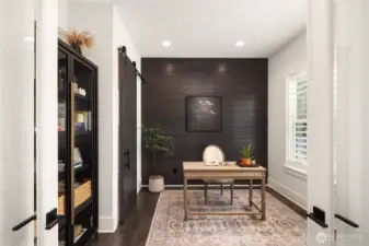 A versatile office space—easily convertible to a guest suite—complements the main level along with an adjacent three-quarter bath, providing single-level living when desired.