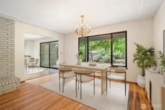 Dining room with a view toward the kitchen eating area and slider to patio & large backyard! Virtually staged to show potential of this space!