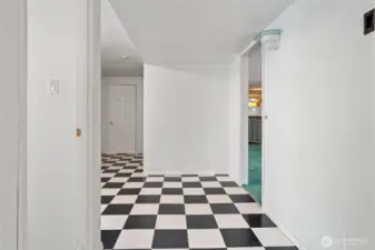 Lower level entry - currently used to access the home. Leads to bathroom, recreation room, storage or workout room, bedroom & 2 car garage.