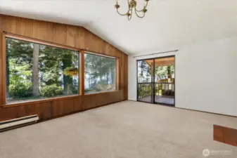 Front door enters into large living area with huge picture windows and access to the porch. *Tenant's furnishings have been digitally removed.*