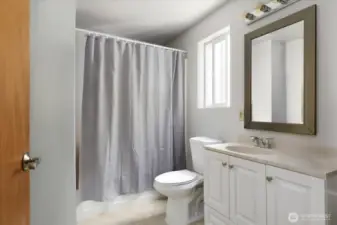 Full bathroom with storage room behind door. *Tenant's furnishings have been digitally removed.*