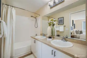 Primary en-suite bathroom with fresh paint, new light fixture, refresh countertops, and double sinks!