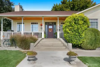 Covered front patio offers shade and a welcoming outdoor space