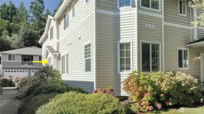 Side entry into home with five steps up to a covered porch area.