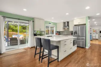 Updated kitchen with stainless appliance package, farmhouse sink and walk-in pantry.