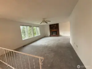 Living room with fireplace and outstanding view from large picture windows