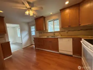 Kitchen has door to back patio and fenced area