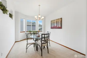 Elegant dining room with bay window is conveniently located just across from the kitchen to make hosting dinner parties a breeze.
