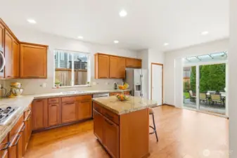 Island seating and pantry compete this lovely kitchen.