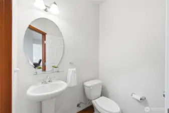 Downstairs powder room is just far enough from the great room for privacy.
