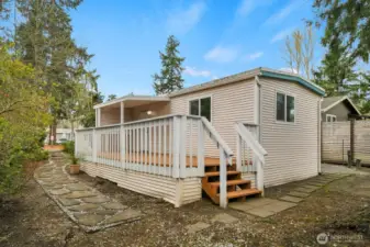 Back view of the home with stairs down from the rebuilt deck to your garden area. Room for your 'Green Thumb' to have fun!