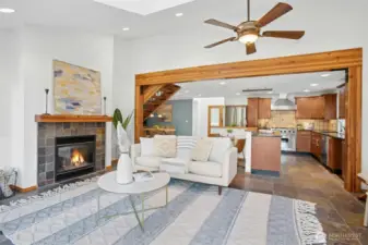 Open-concept kitchen/living area w/ a cozy gas fireplace