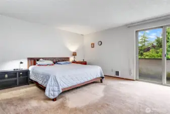 Spacious primary bedroom with double closets, private deck and en suite bath