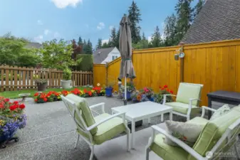 Fenced patio area off kitchen, your choices for garden color, planters, outdoor furniture with umbrella (fence freshly painted), sweet bird bath, storage.