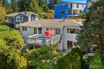 The main level has a large view deck with stairs to the lovely landscaped back yard with huge tile patio