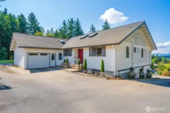 This home has a full circular driveway with plenty of parking. A garage up top and a 2 car garage below.