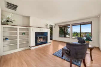 Main living room with a custom built fireplace and bookshelves.