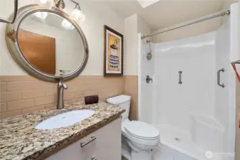 3/4 bath next to the laundry room and upper garage. There is a hidden medicine cabinet beneath the artwork on the wall.