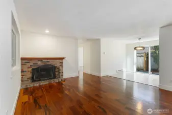 Living room with fireplace, kitchen to right
