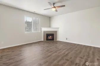 Open living area featuring a warm and inviting gas fireplace