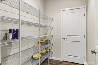 Convenient walk-in pantry opens to the garage for easy grocery drop-off