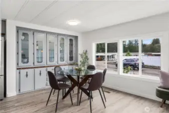 Bright dining area with NEW LED lighting, lit built-in credenza and expansive windows creates a cheerful space for everyday meals or hosting guests.