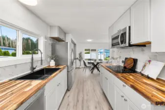 Updated kitchen shines with NEW butcher block countertops, NEW Shaker cabinetry, NEW backsplash and a spacious layout designed for both cooking and entertaining.