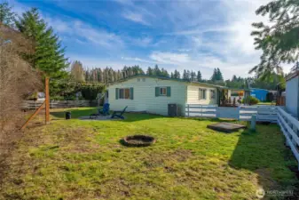 Expansive fully fenced backyard provides open green space perfect for entertaining, gardening, or enjoying the outdoors.