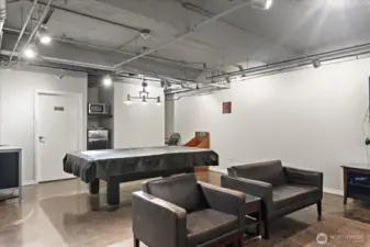 Game room with fridge and standup bar.