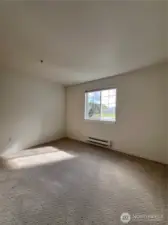 spacious guest bedroom with a view