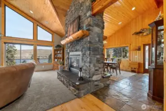 Double-sided floor-to-ceiling stone fireplace.