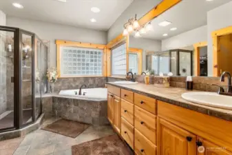 Primary bathroom with heated tiled floors, walk-in shower, and separate soaking tub.